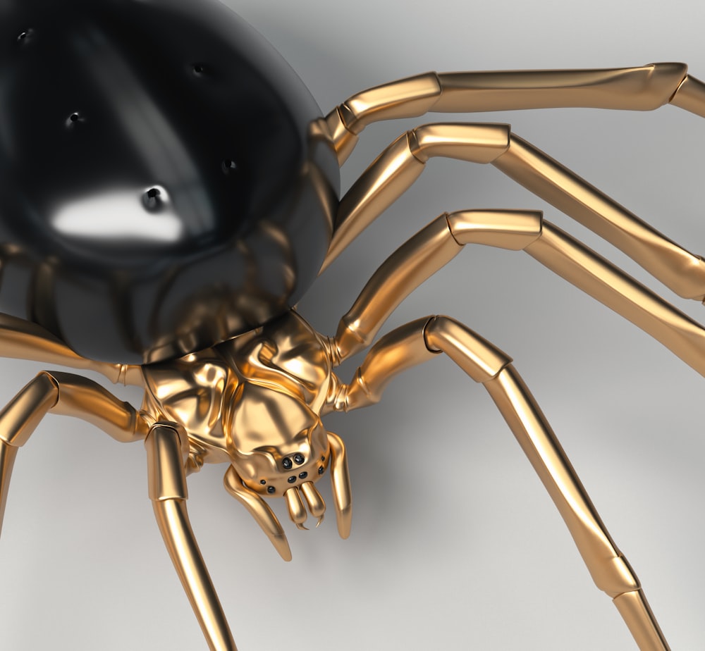 a golden spider with a black ball on its back