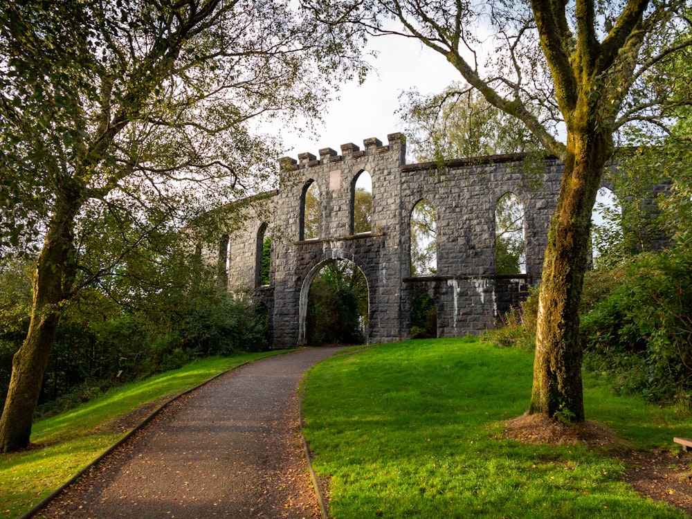 a stone building sitting on top of a lush green field