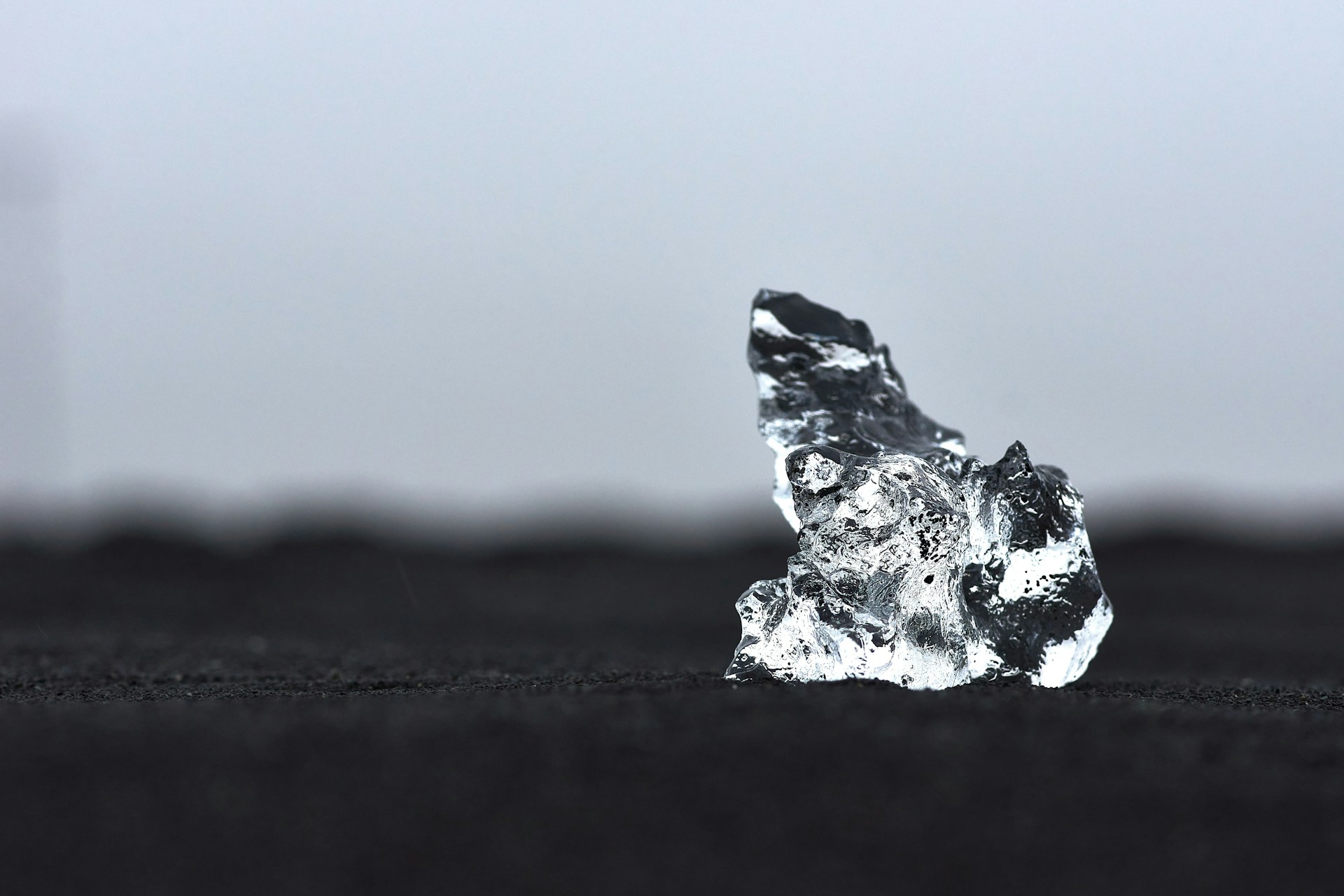 a piece of ice sitting on top of a black surface