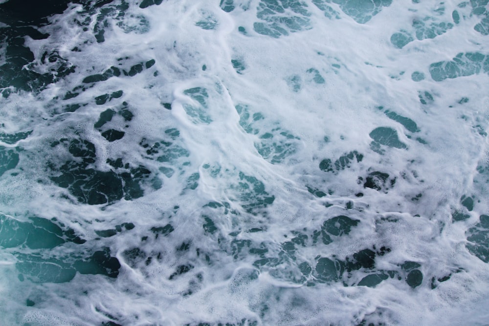 an aerial view of the ocean with waves