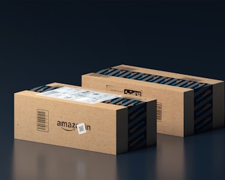 two boxes of amazon are stacked on top of each other