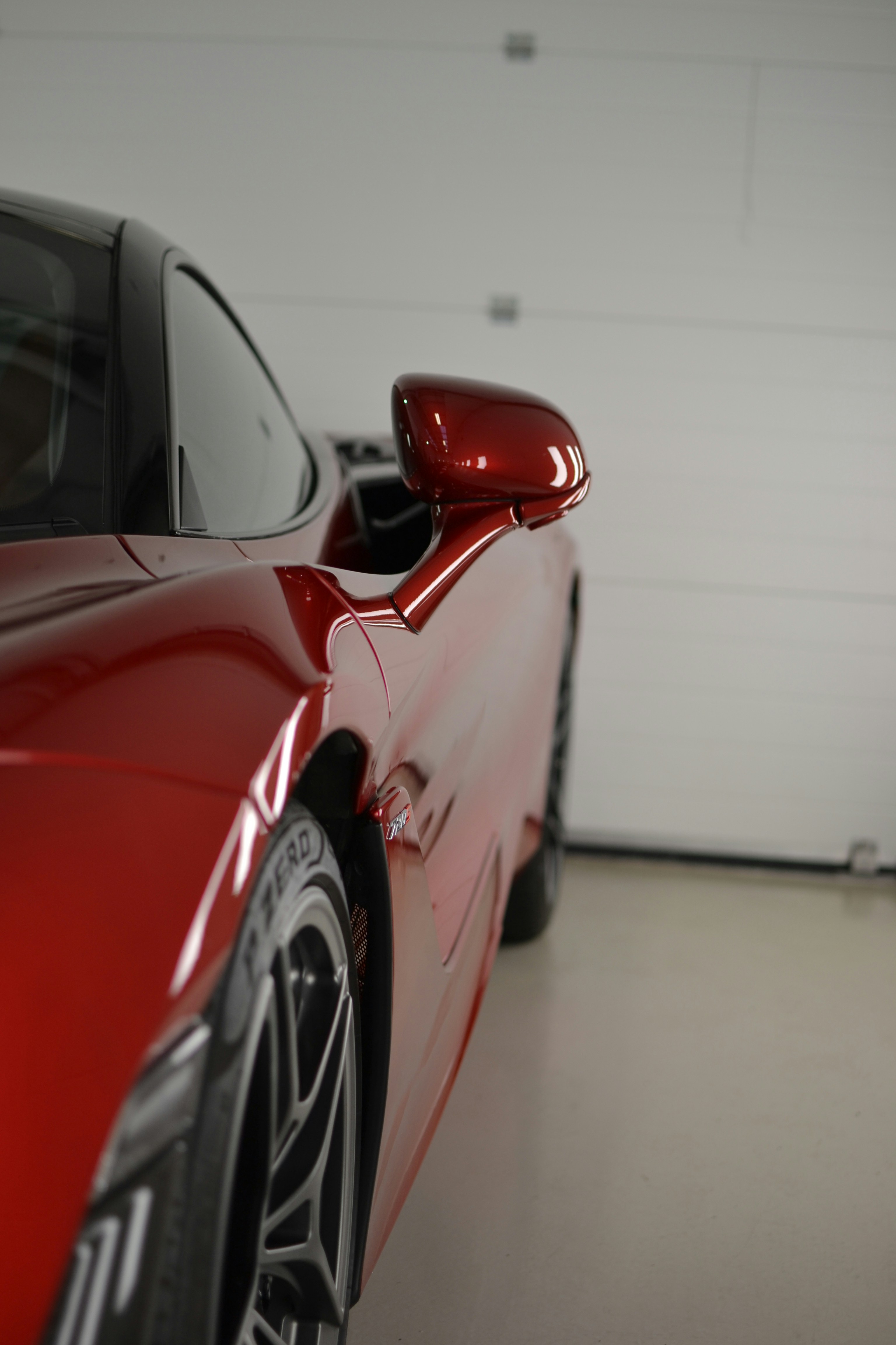 a red sports car parked in a garage