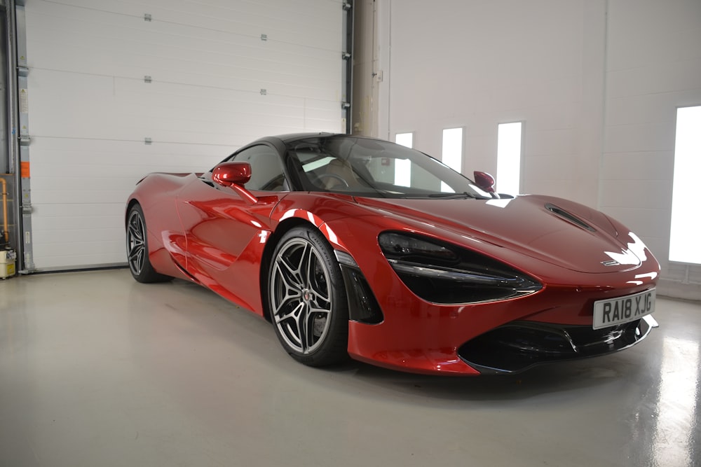 a red sports car parked in a garage