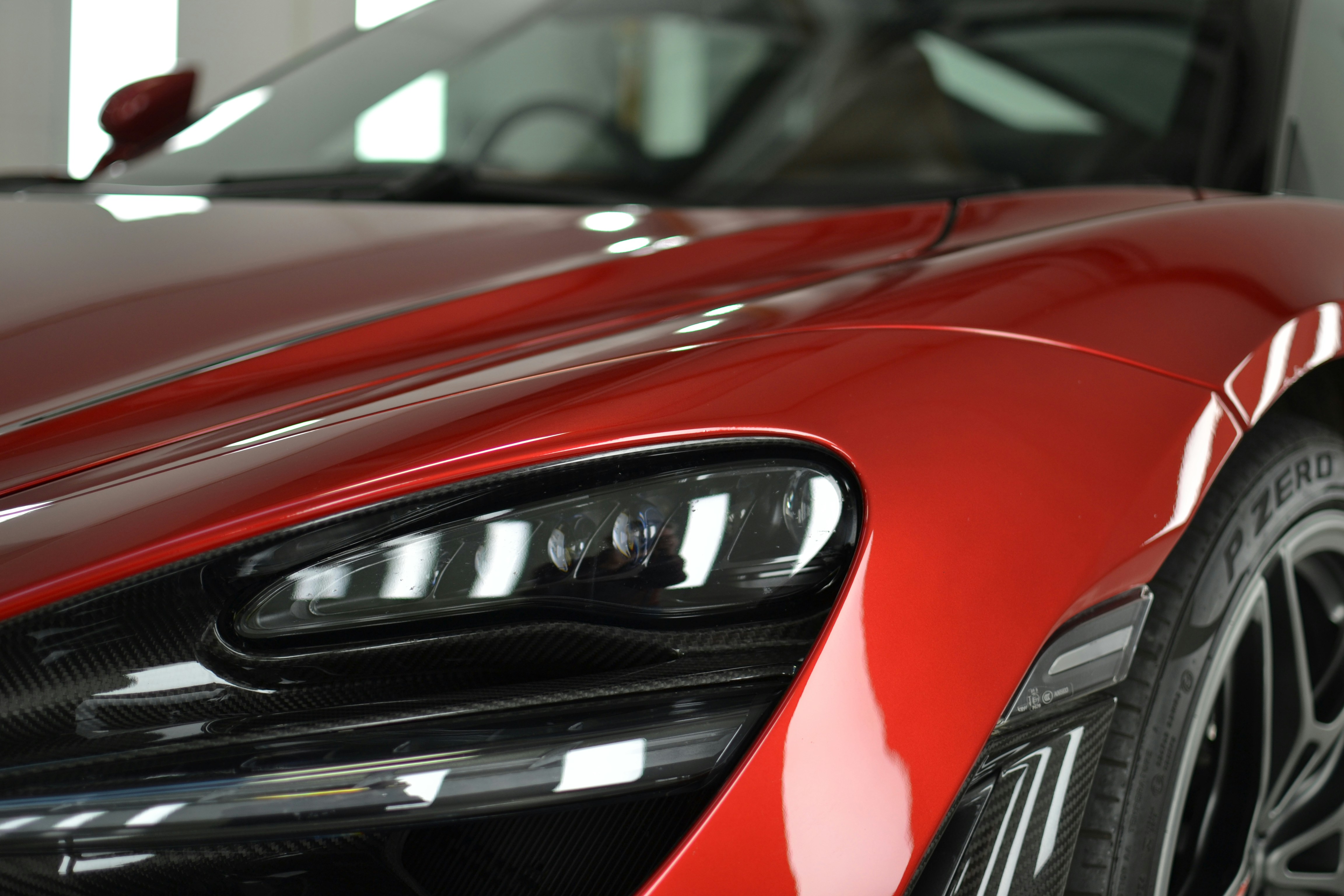 a close up of the front of a red sports car