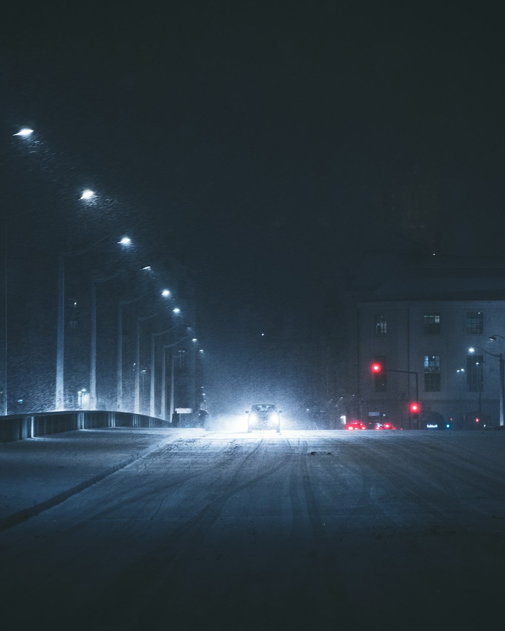 a car driving down a street at night