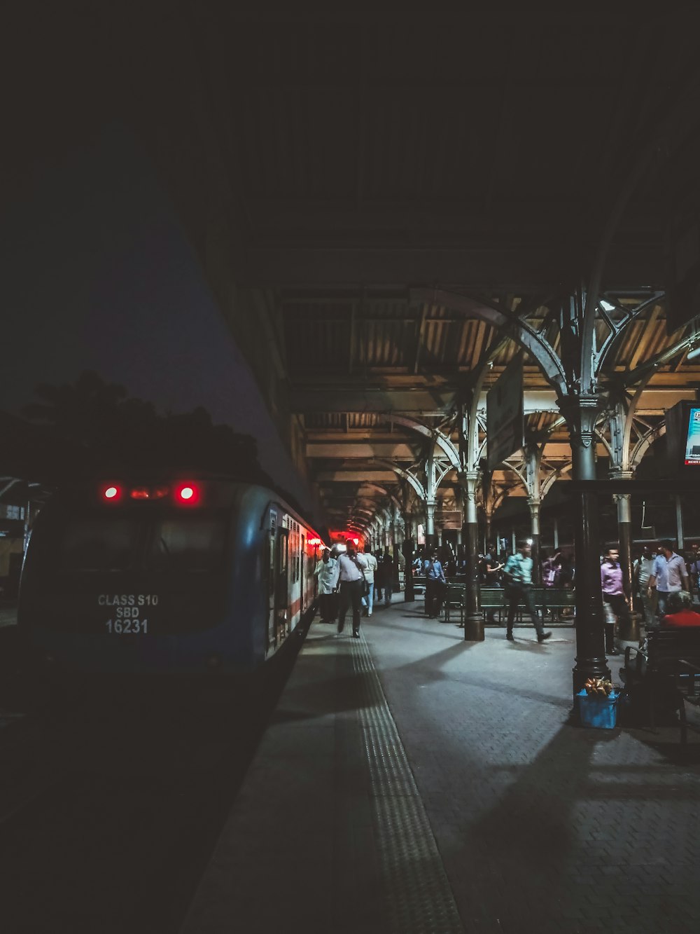 a train pulling into a train station at night