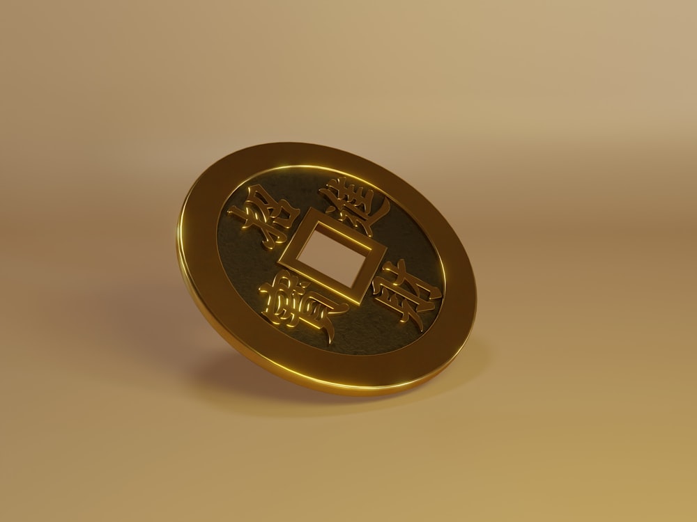 a gold coin with a chinese writing on it