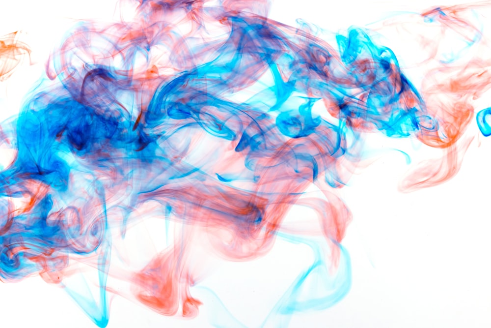 blue and red smoke is shown against a white background