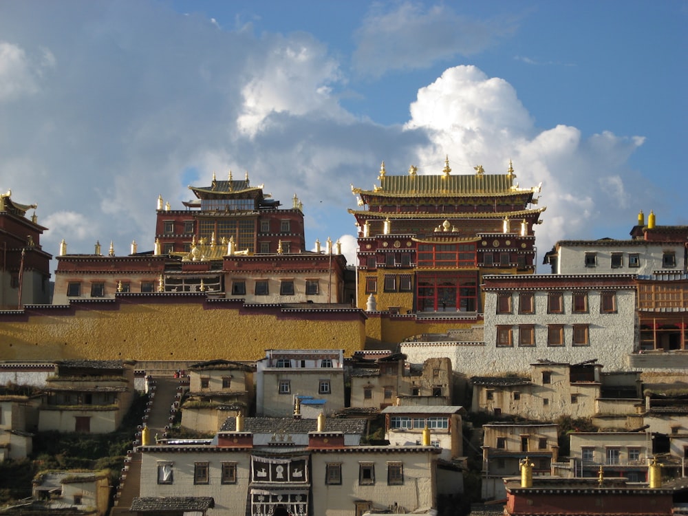 a group of buildings with a cloudy sky in the background