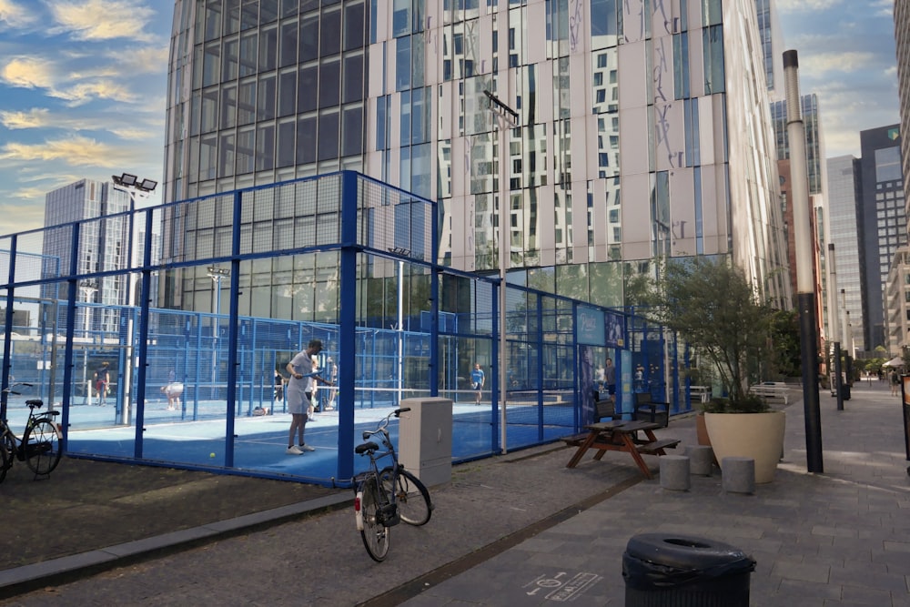 a large building with a blue fence around it