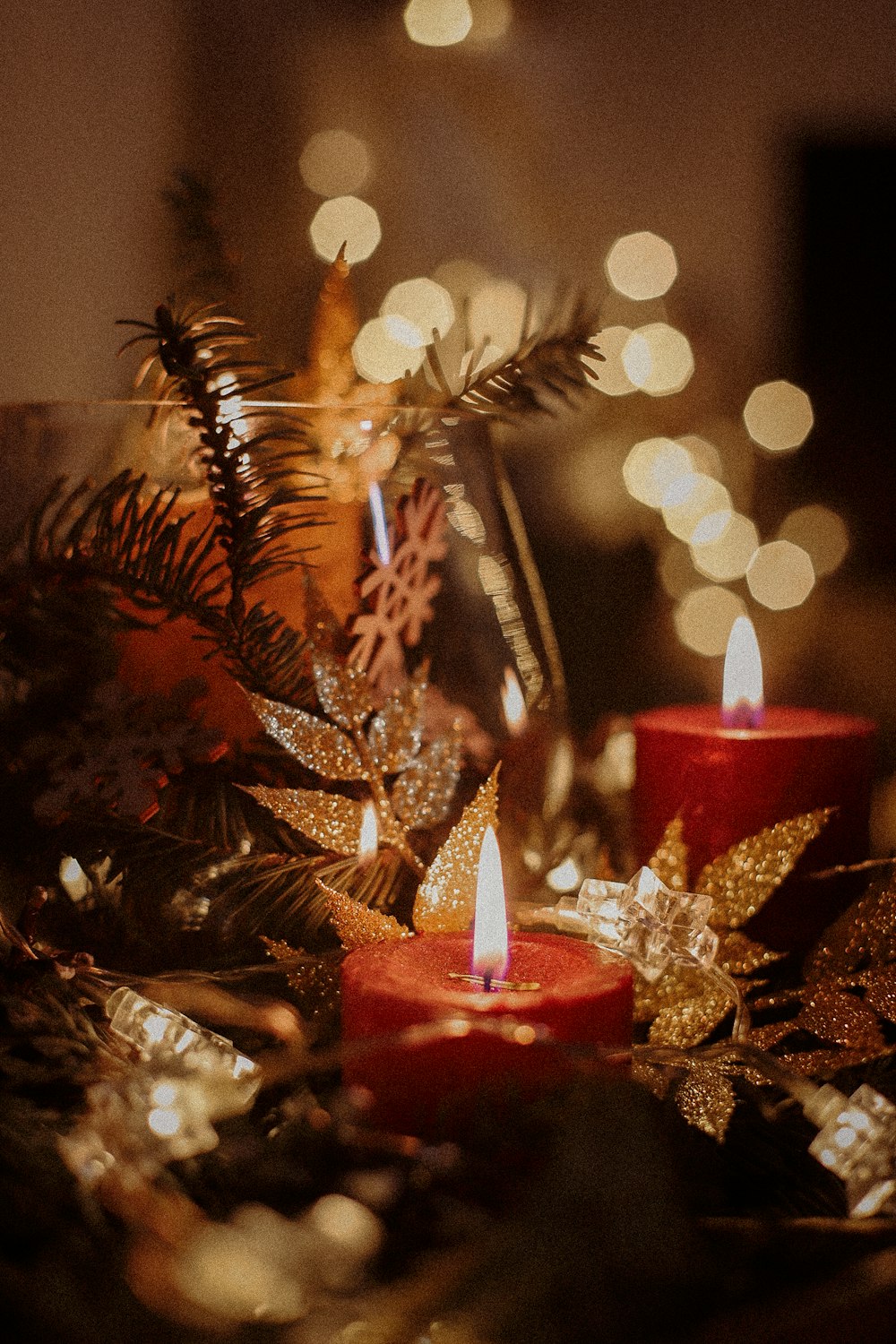 a table topped with candles and christmas decorations