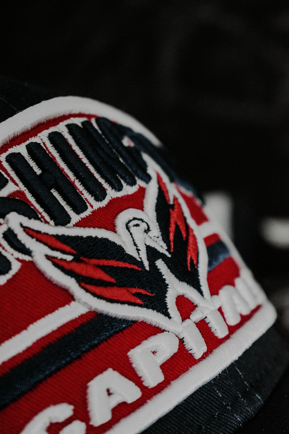 a close up of a red and black cap