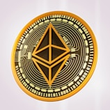 A digital representation of an Ethereum coin featuring a network-like pattern and binary code surrounding the Ethereum logo in the center. The coin has a gold and black color scheme.
