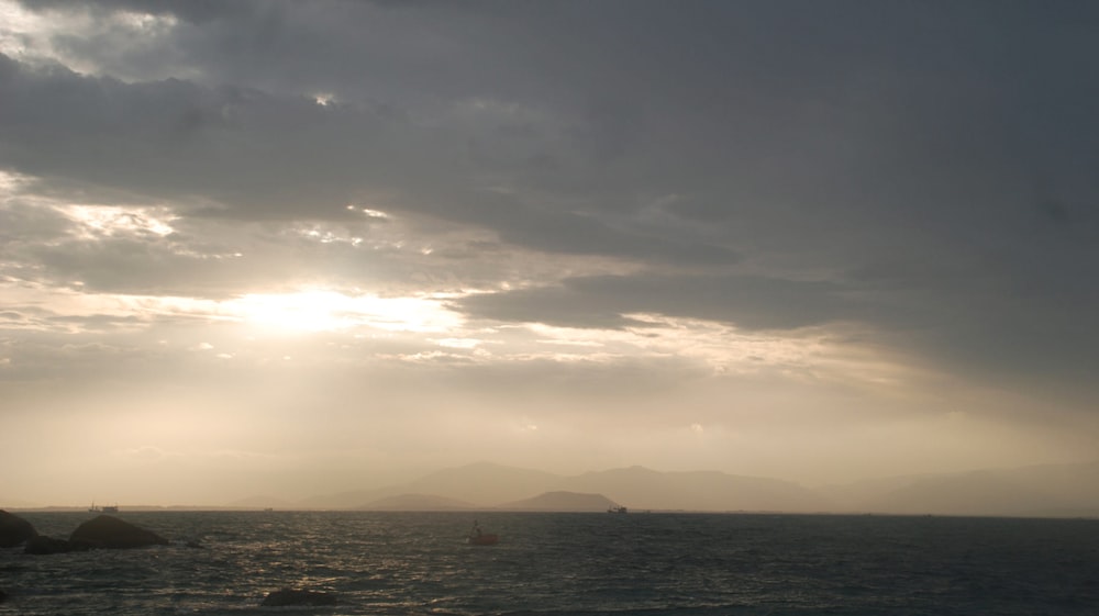 a large body of water under a cloudy sky