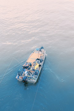 a small boat in the middle of the ocean