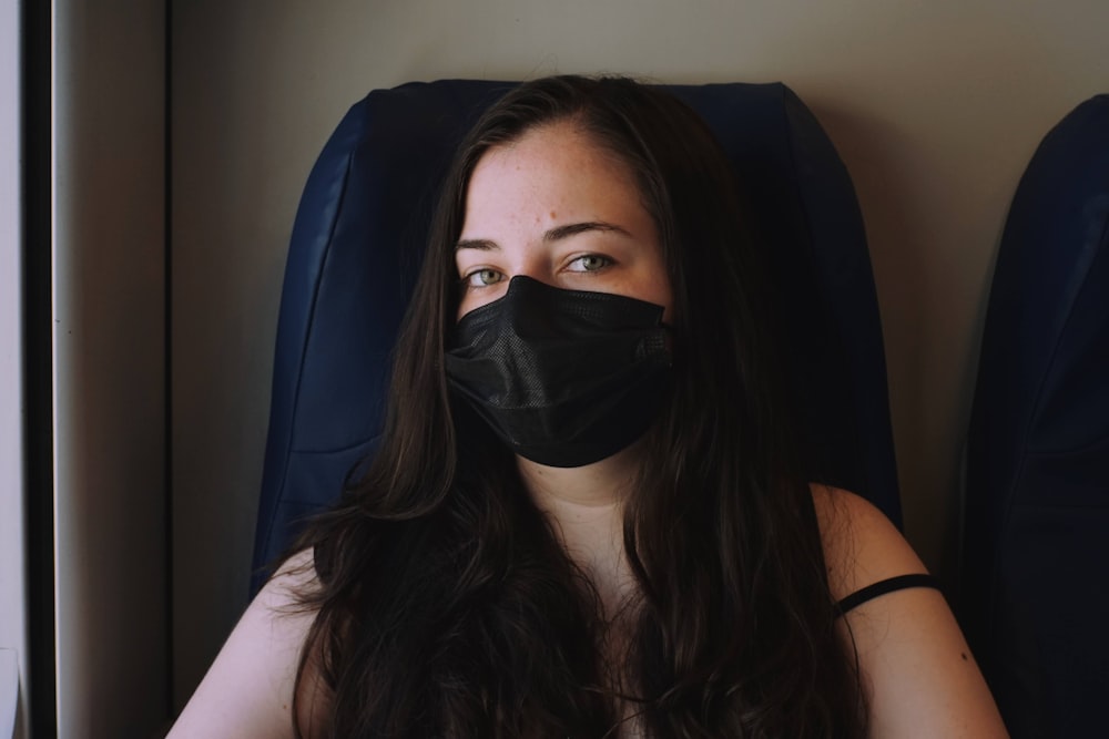 a woman with a black mask on her face