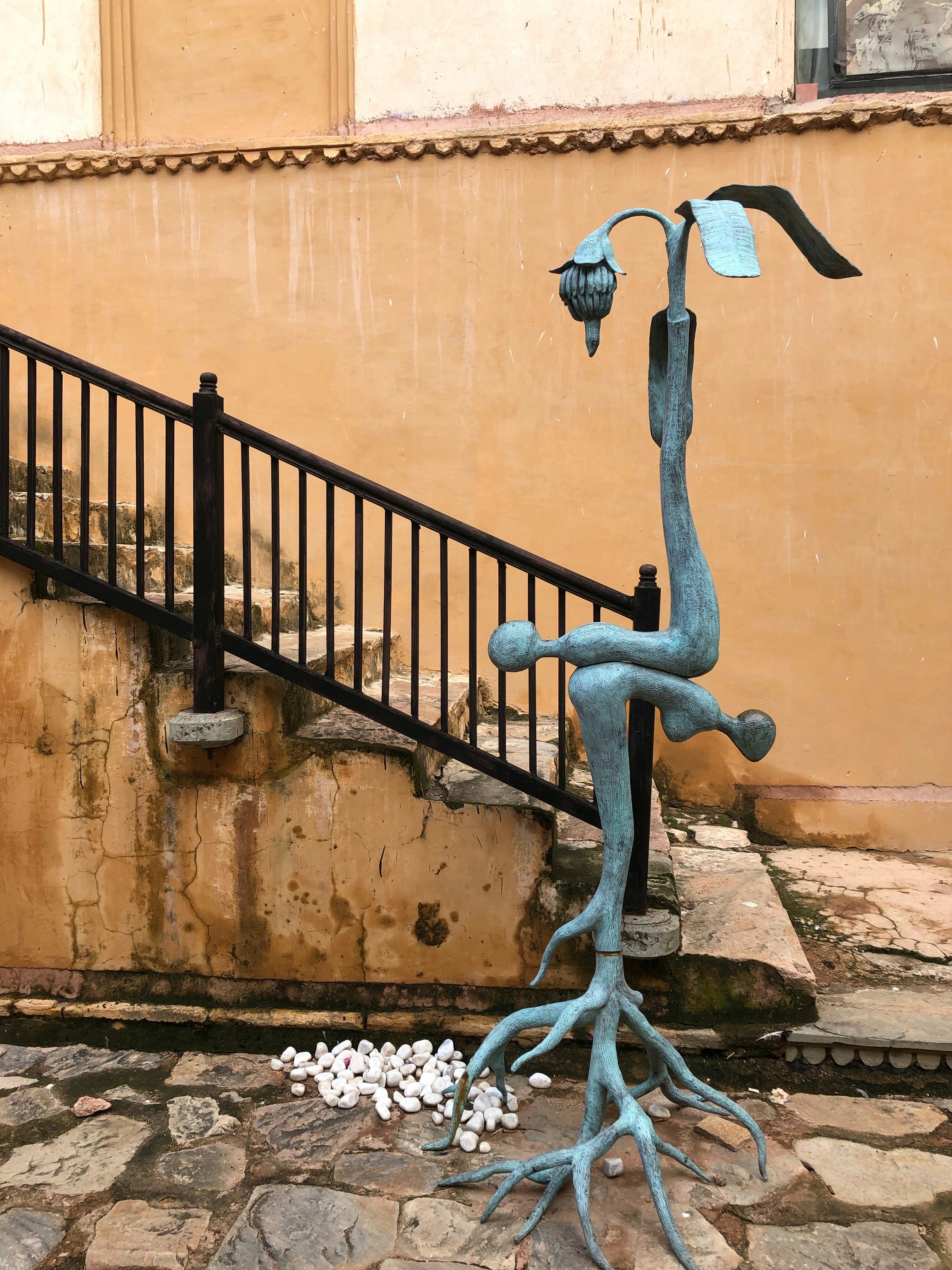 a statue of a tree with a bird on it