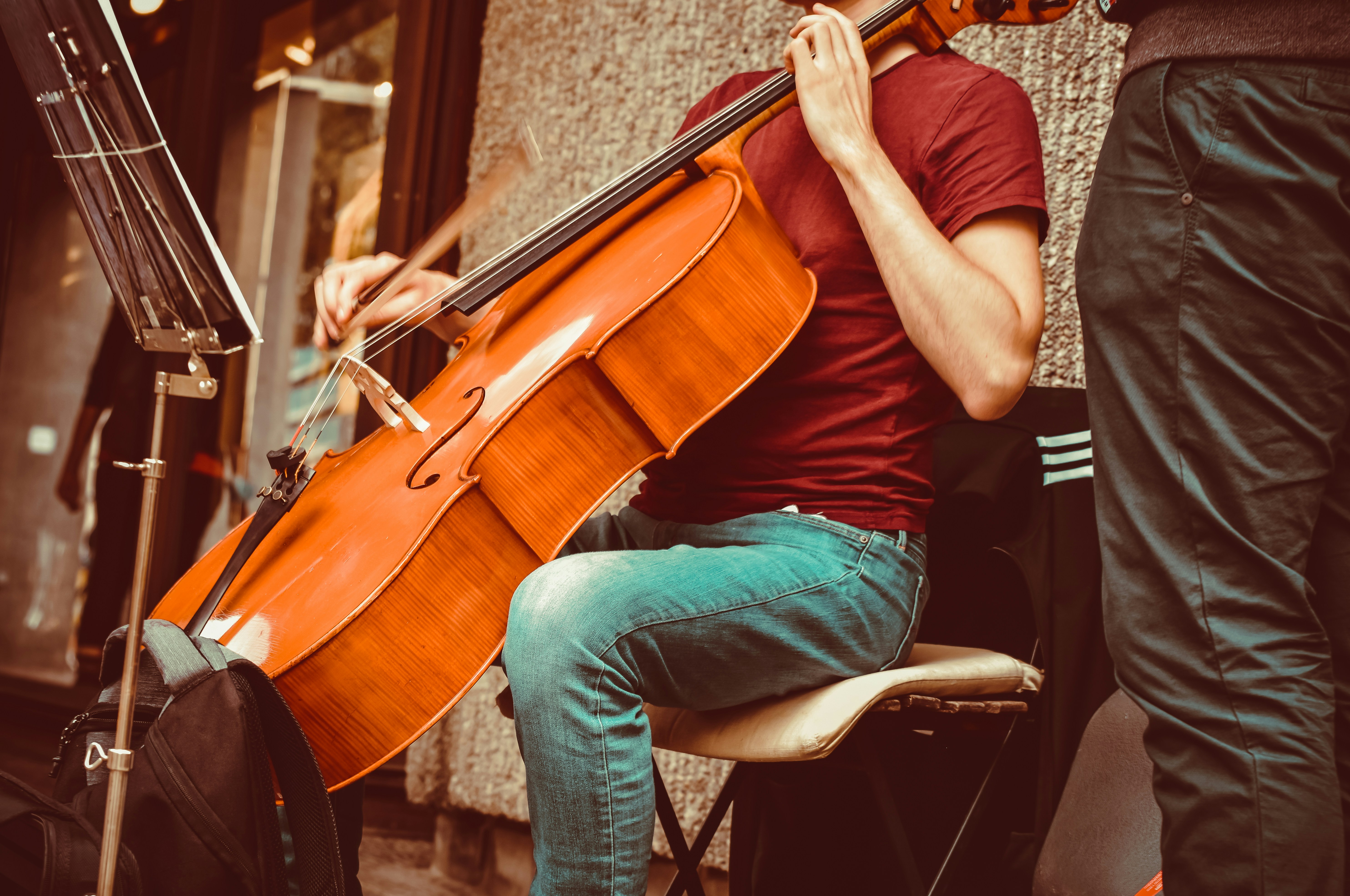 a man sitting on a chair playing a violin