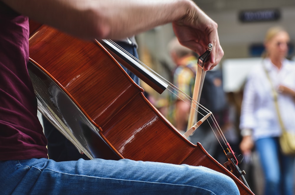 a person holding a guitar in their hand