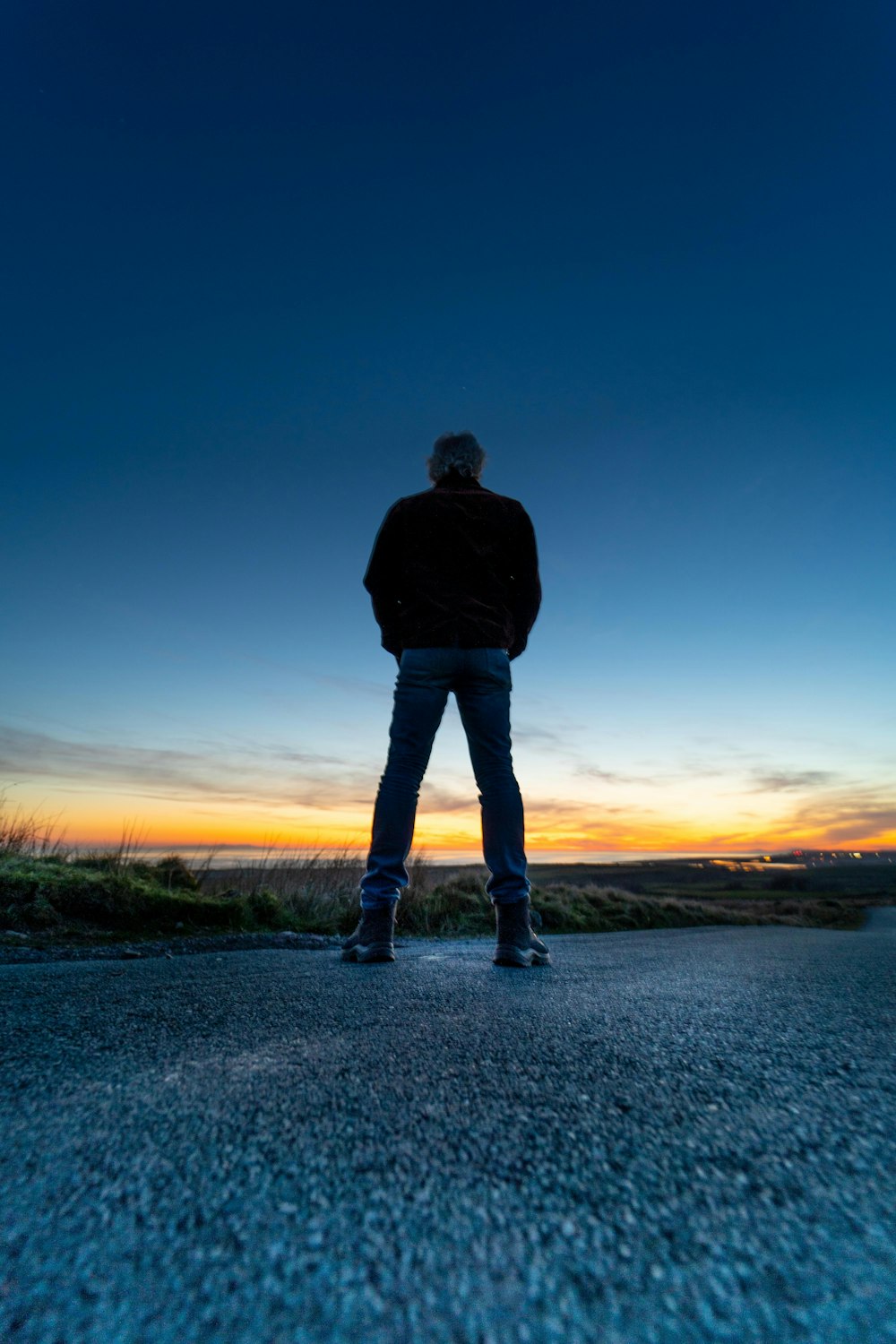 A man standing in the middle of a road at sunset photo – Free Wast ...