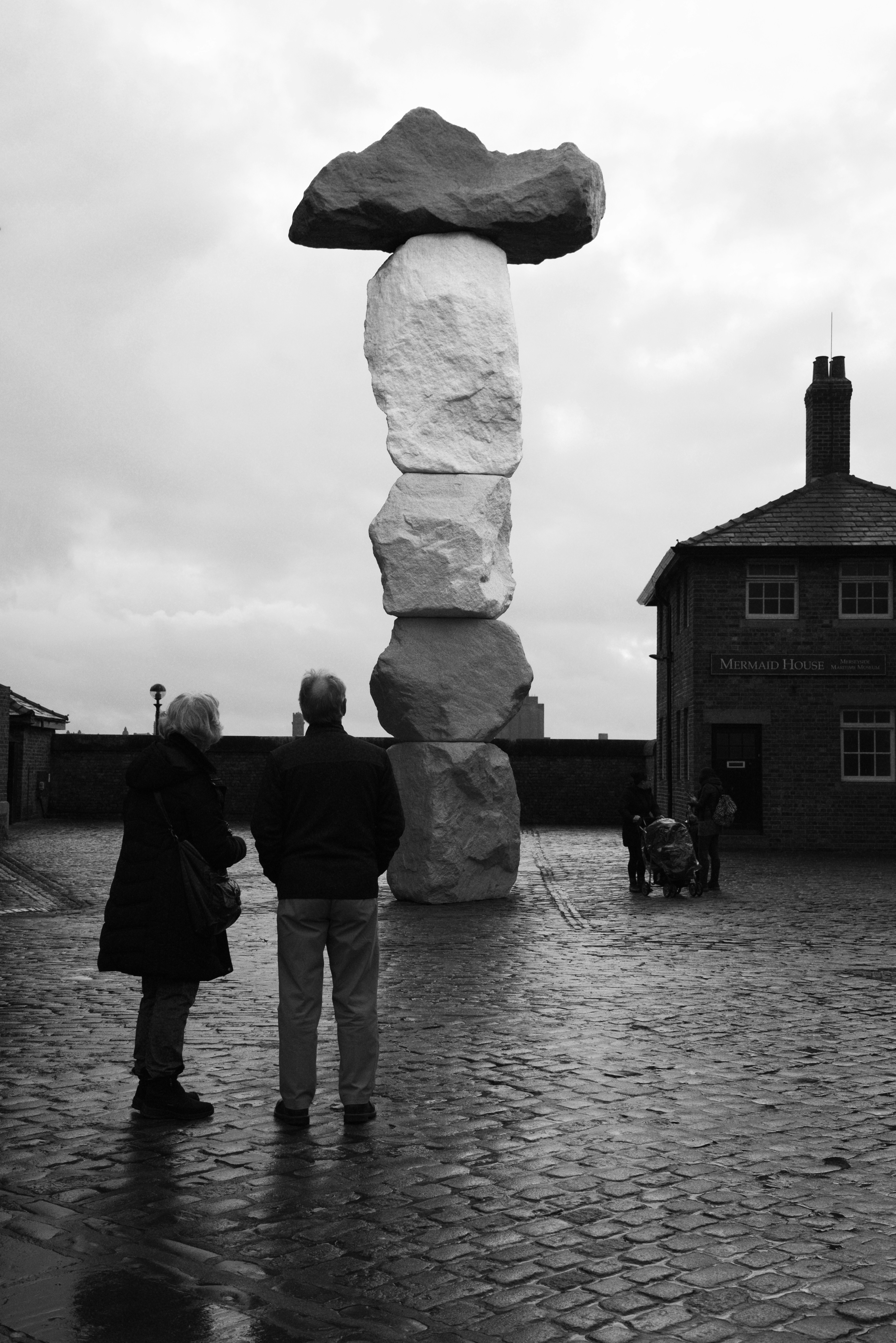 a couple of people that are standing in the rain