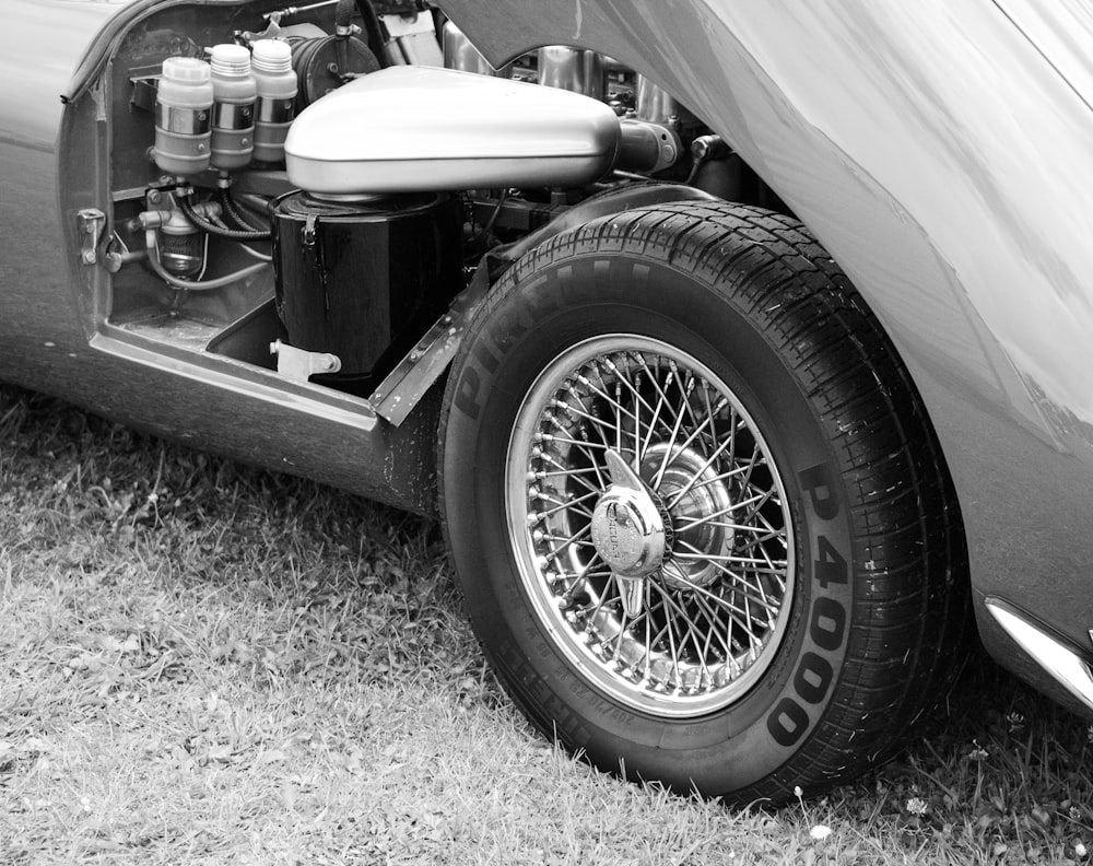 an old car with the hood open and the engine visible