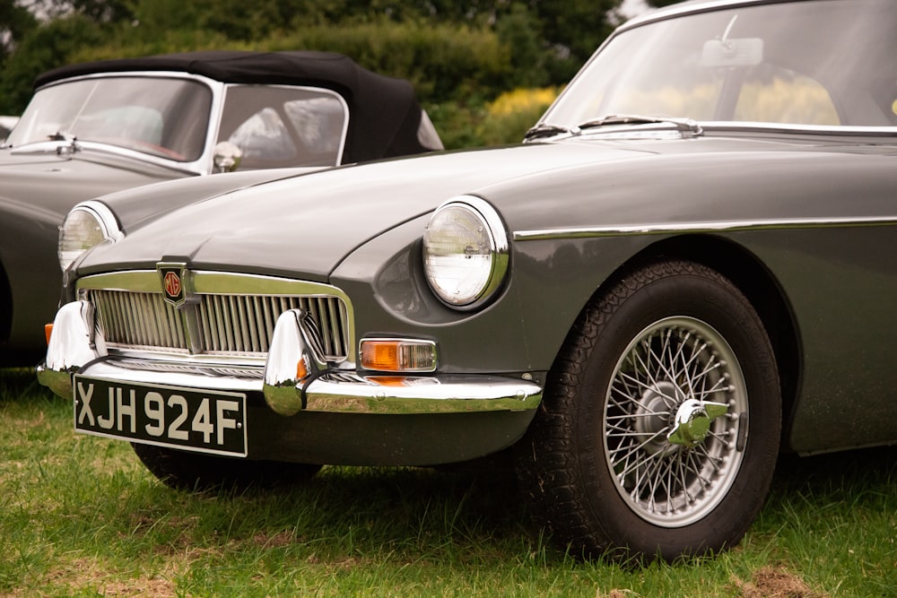 a couple of cars that are sitting in the grass