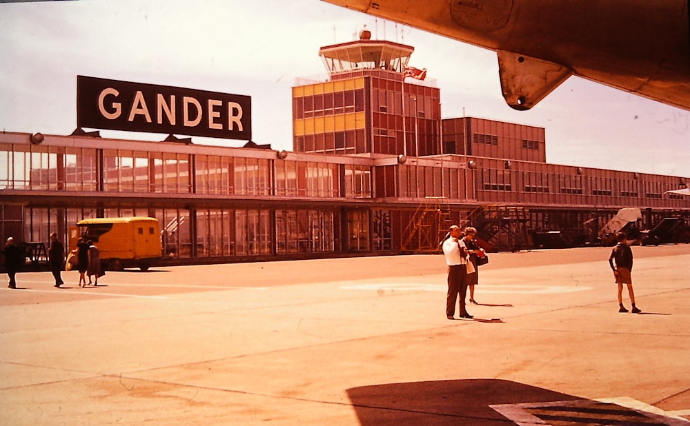 a couple of men standing in front of an airplane