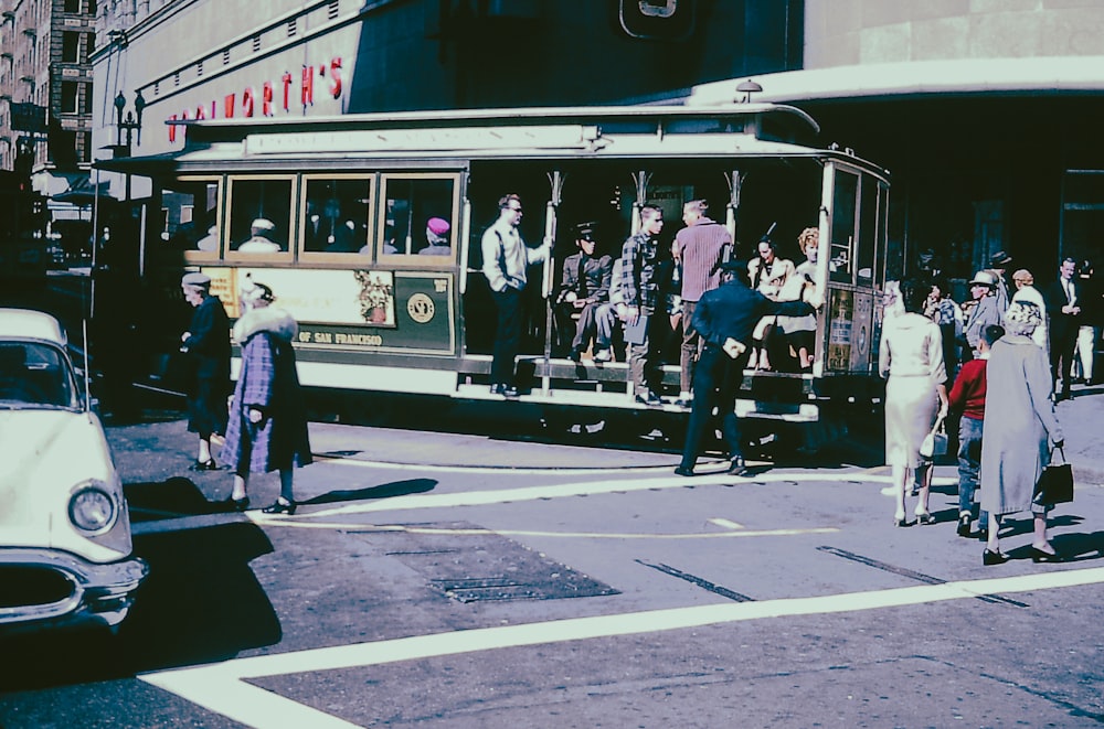 a group of people standing on the side of a street