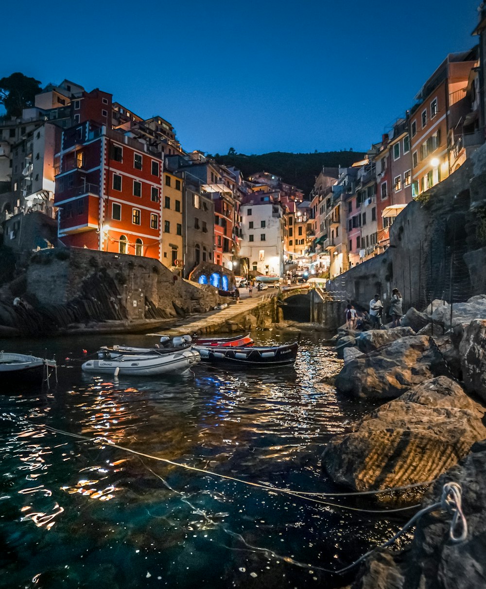 a harbor with boats in the water at night