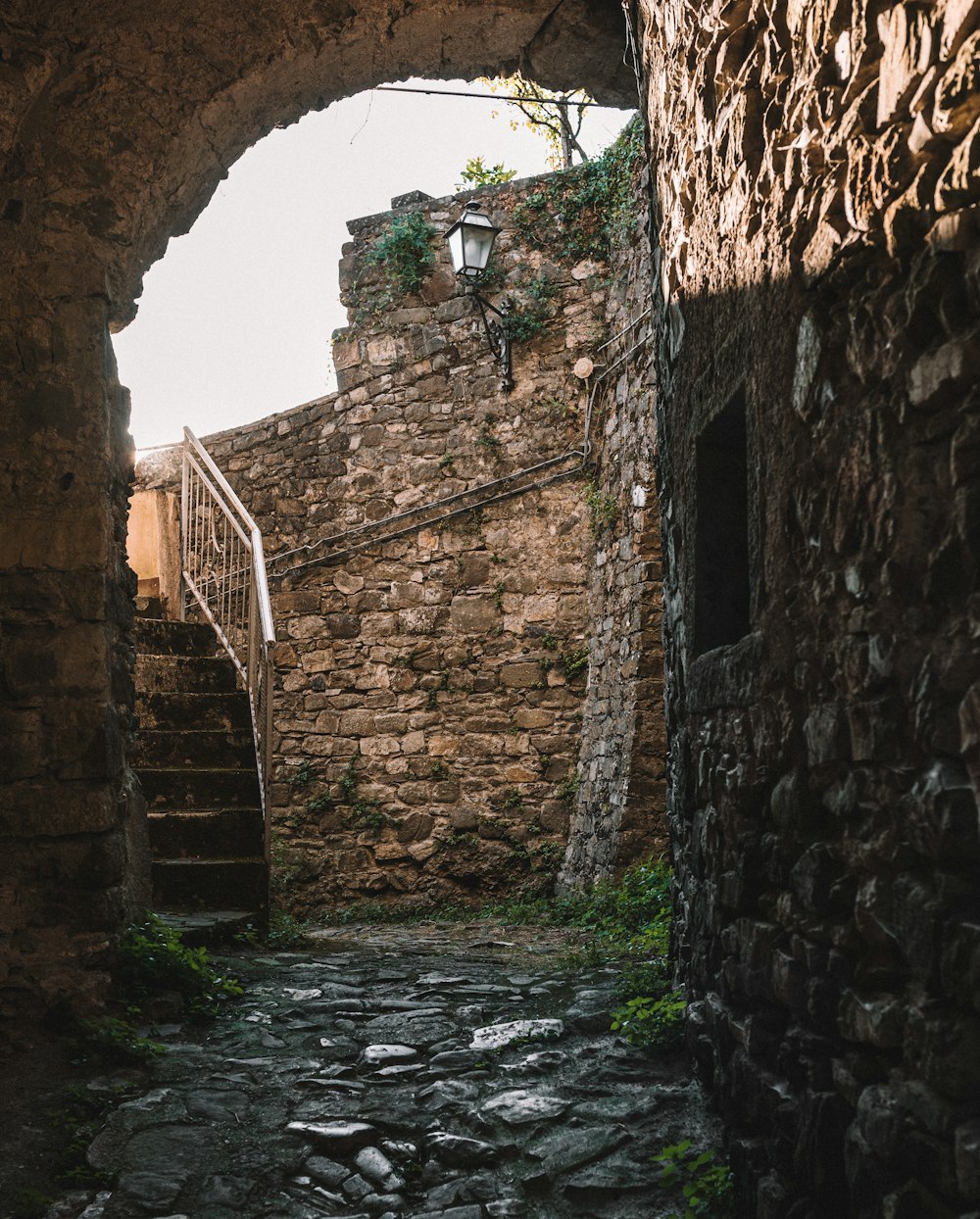 a stone street with a stone staircase going up it