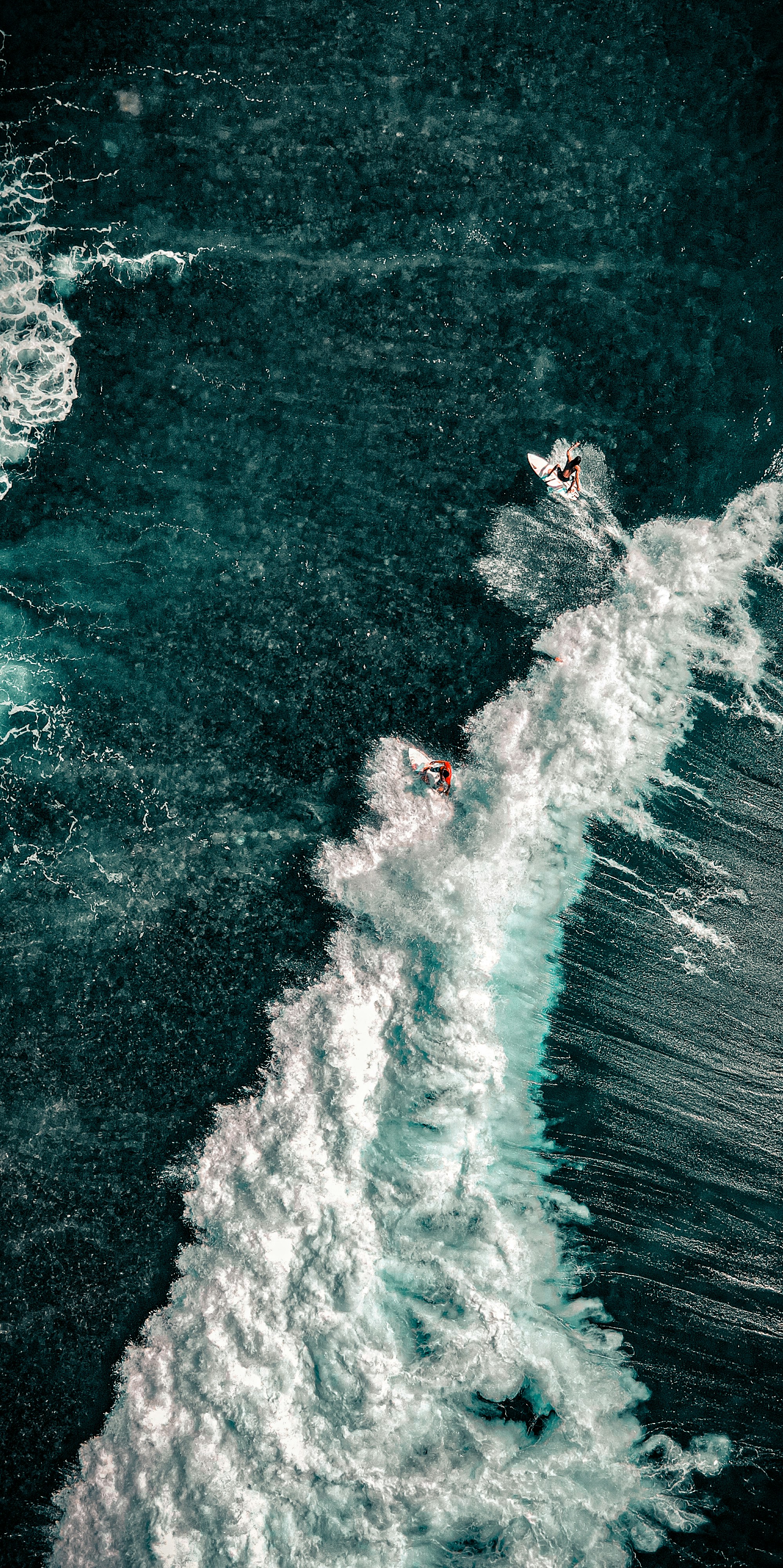 a man riding a surfboard on top of a wave in the ocean