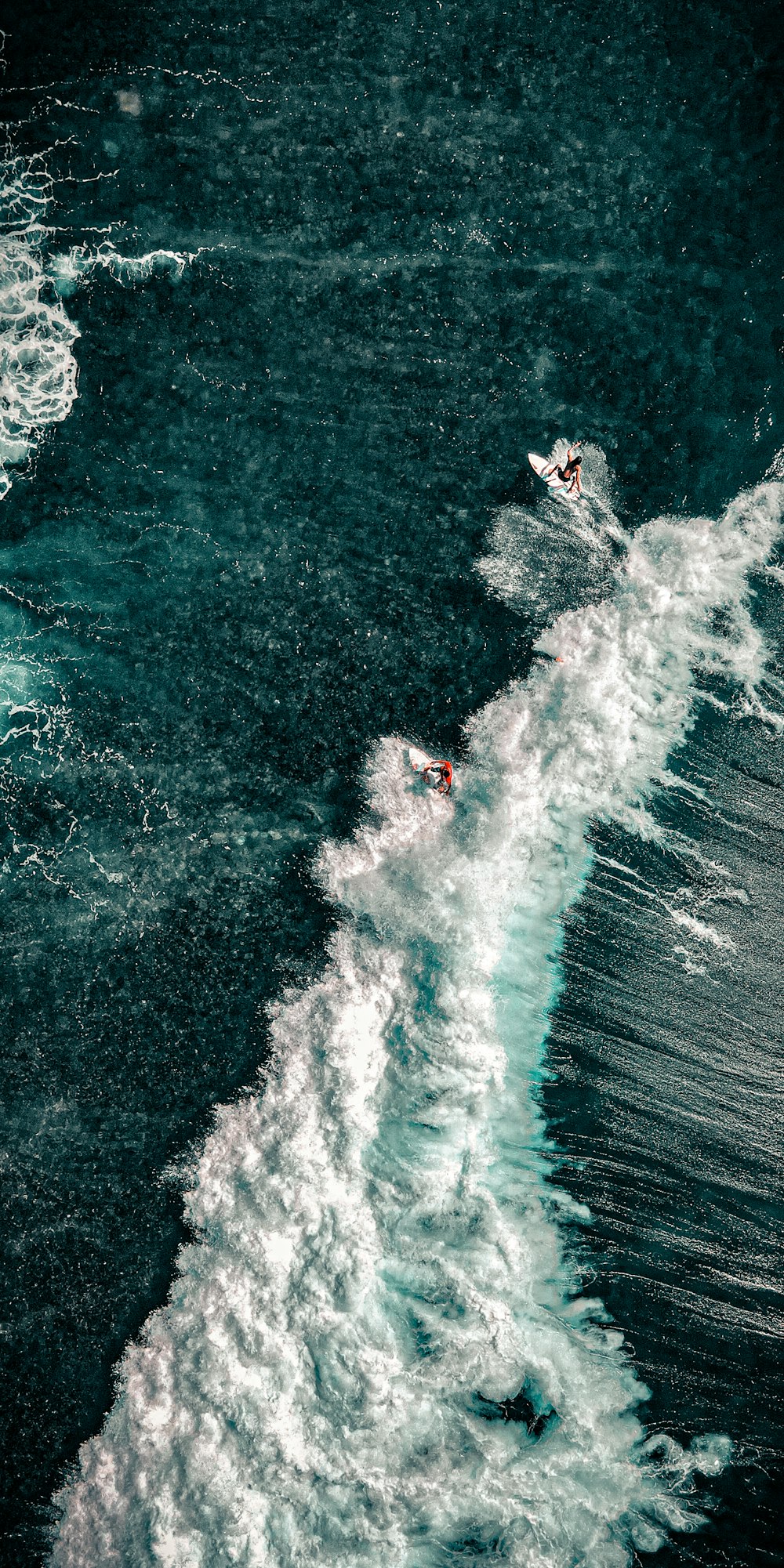 a man riding a surfboard on top of a wave in the ocean