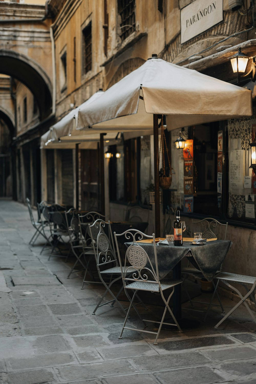 a row of tables and chairs on a sidewalk