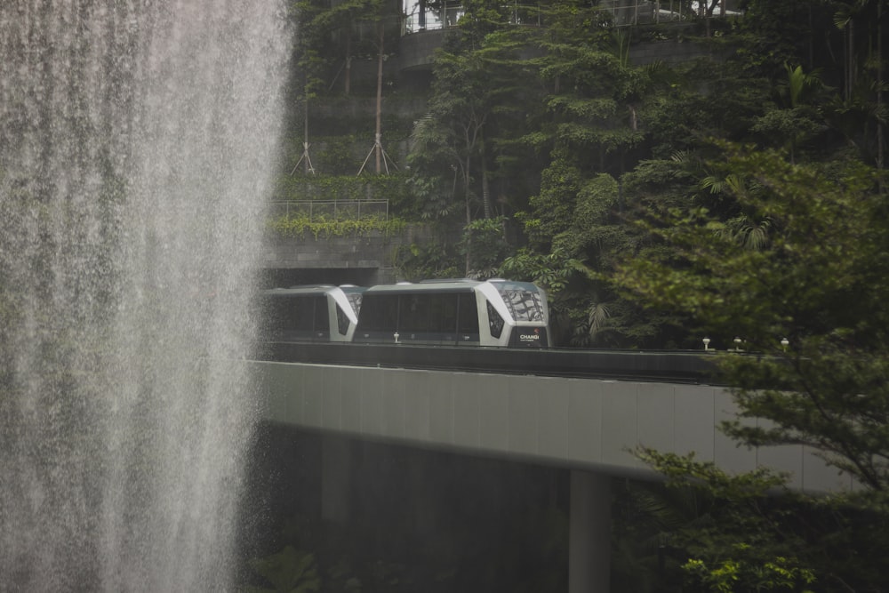 a bridge with a waterfall in the background