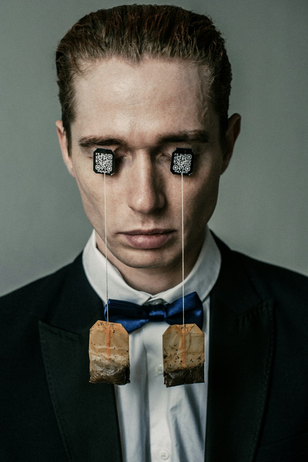 a man in a tuxedo with two pieces of bread attached to his ears