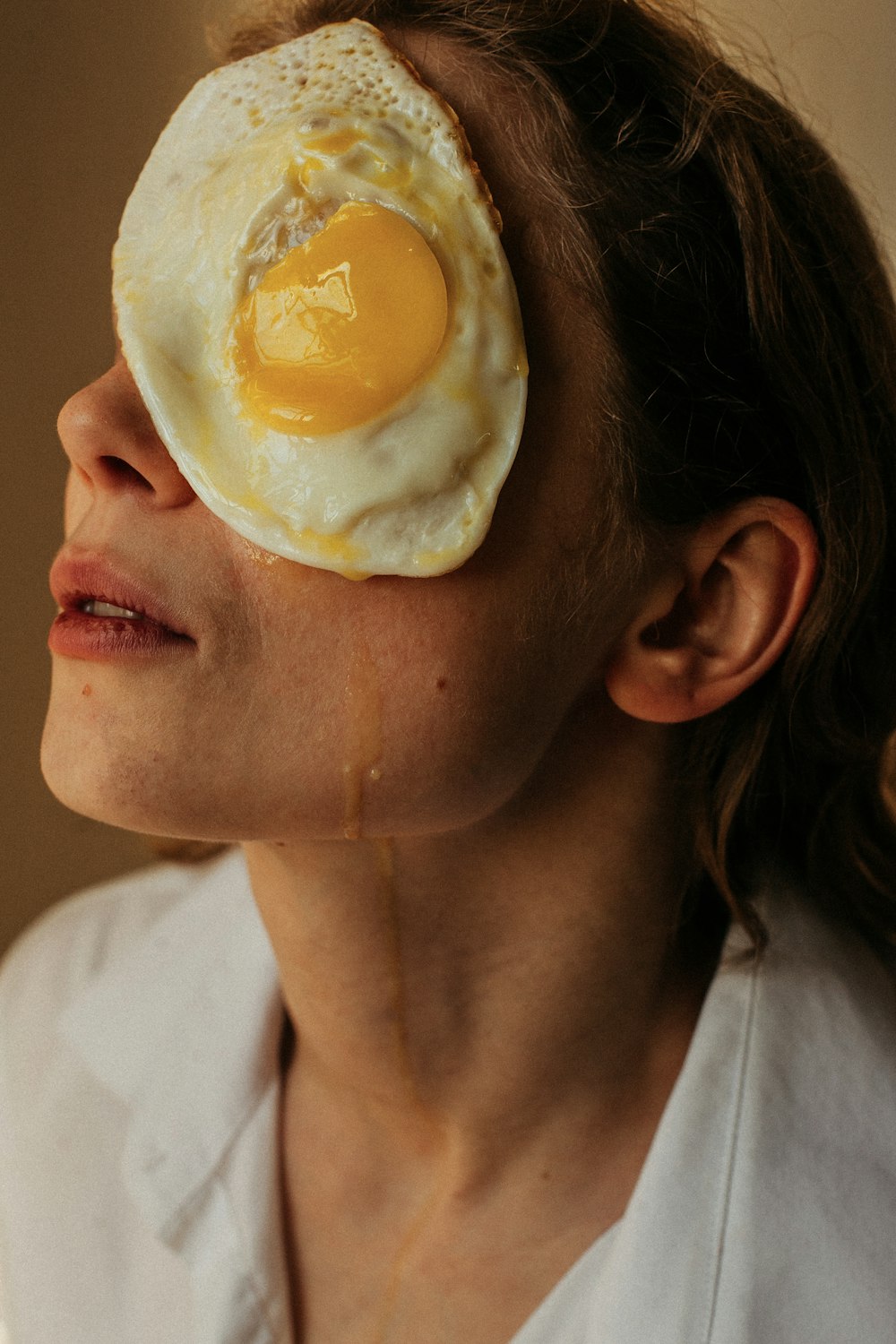 a woman with a fried egg on her face