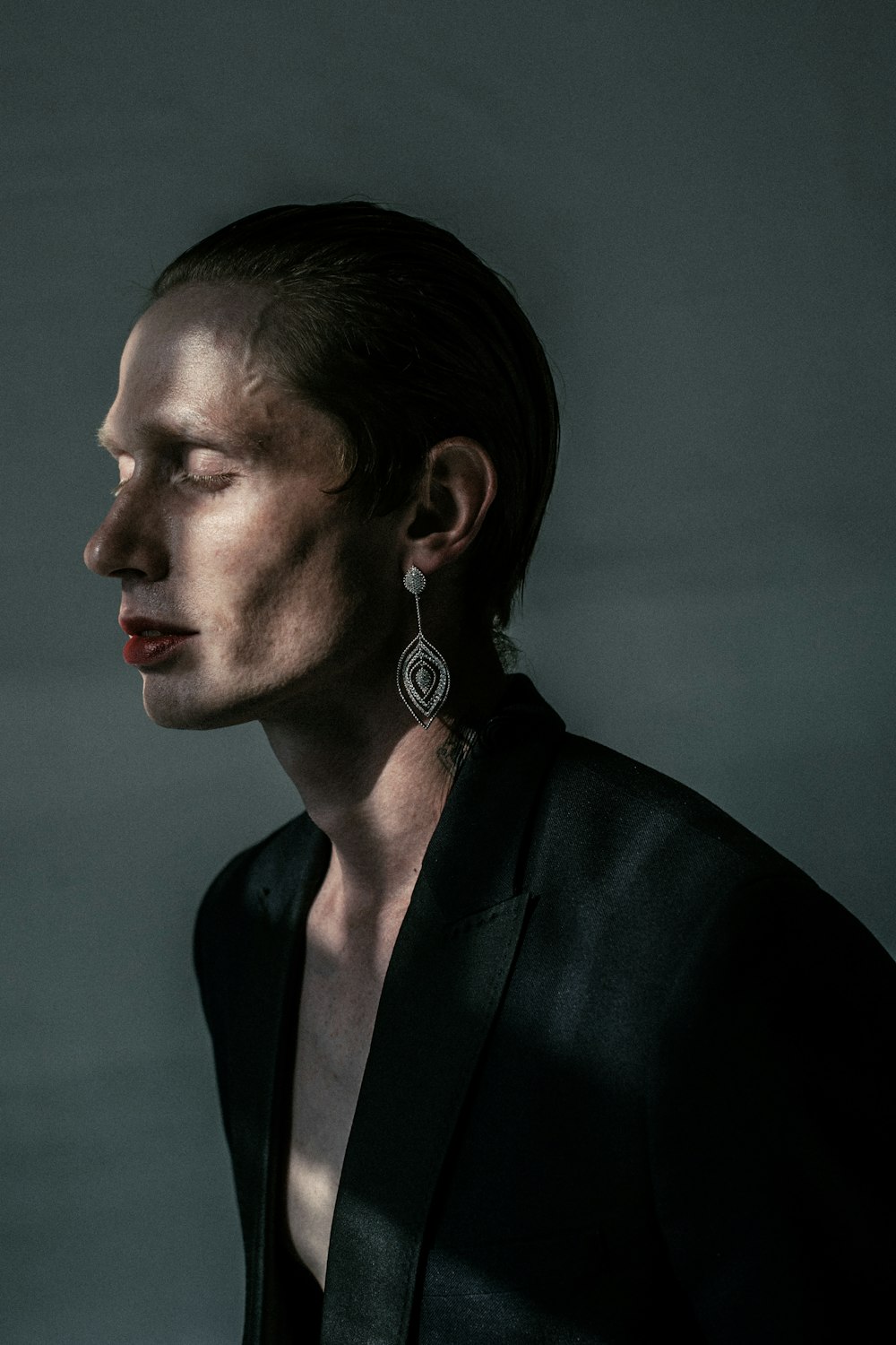 a woman in a black shirt and earrings