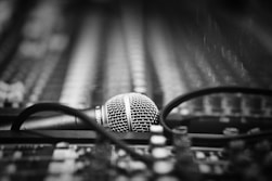 a microphone sitting on top of a table next to a pair of glasses