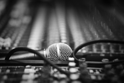 a microphone sitting on top of a table next to a pair of glasses