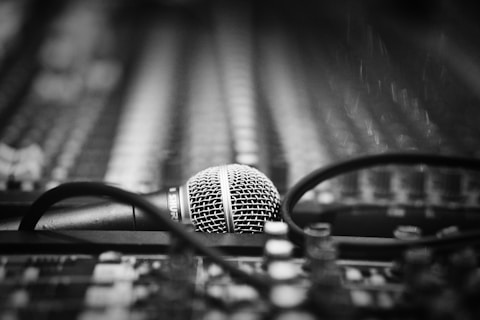 a microphone sitting on top of a table next to a pair of glasses