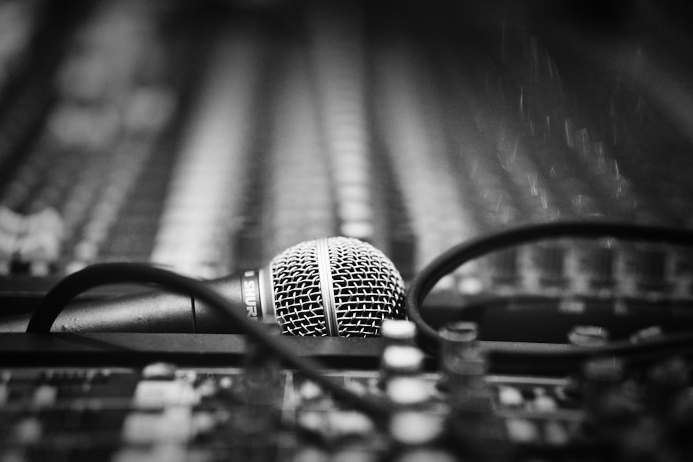 a microphone sitting on top of a table next to a pair of glasses