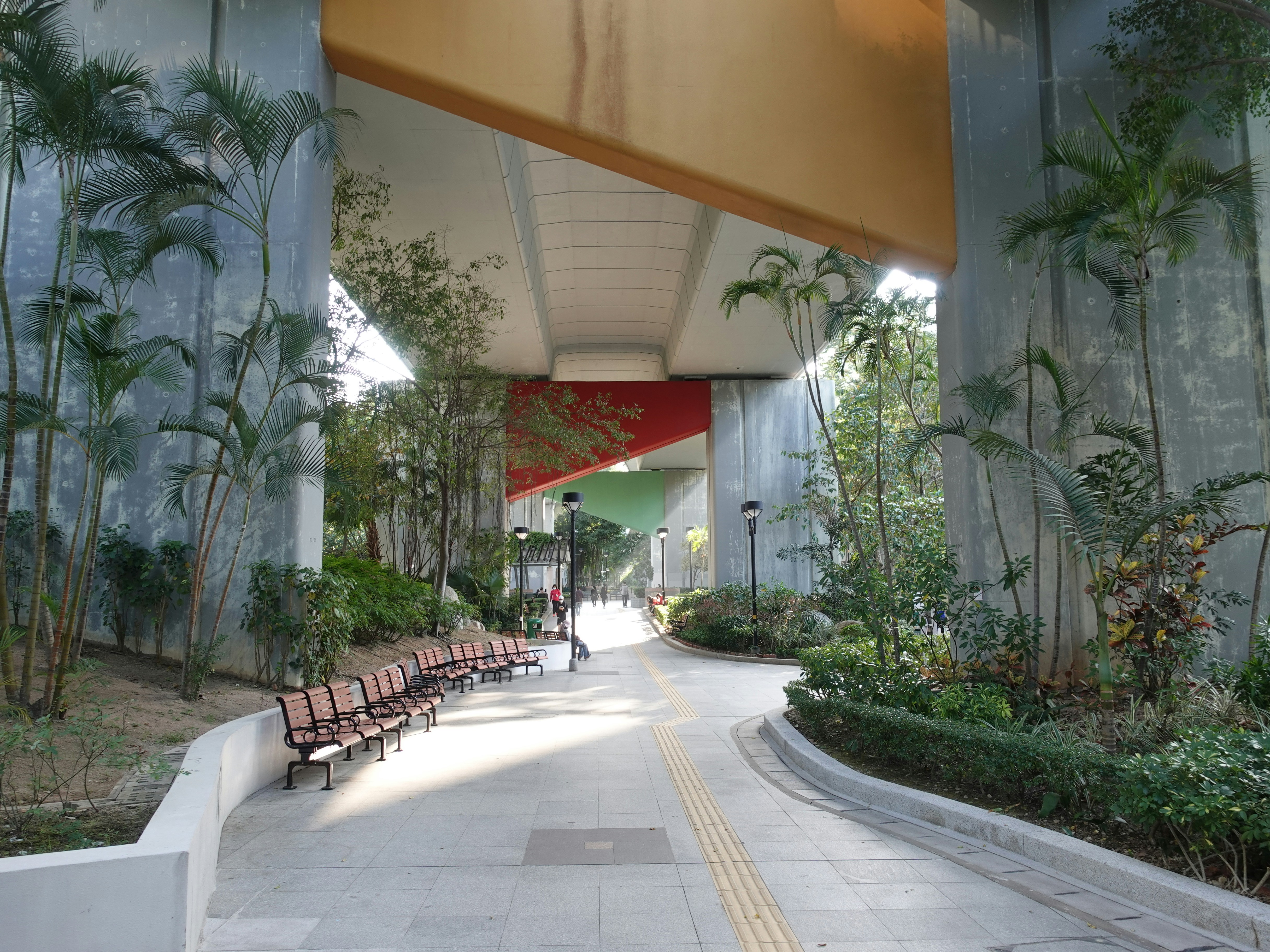 a group of benches sitting under a tall building