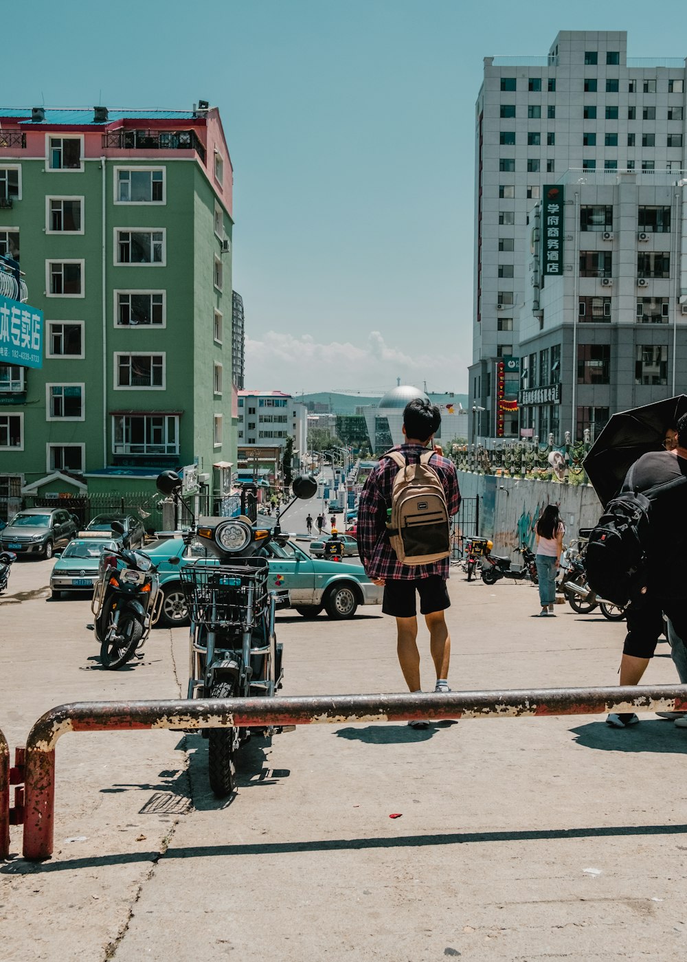 a man with a backpack is standing in the middle of a street