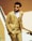a man wearing a tan suit and sunglasses