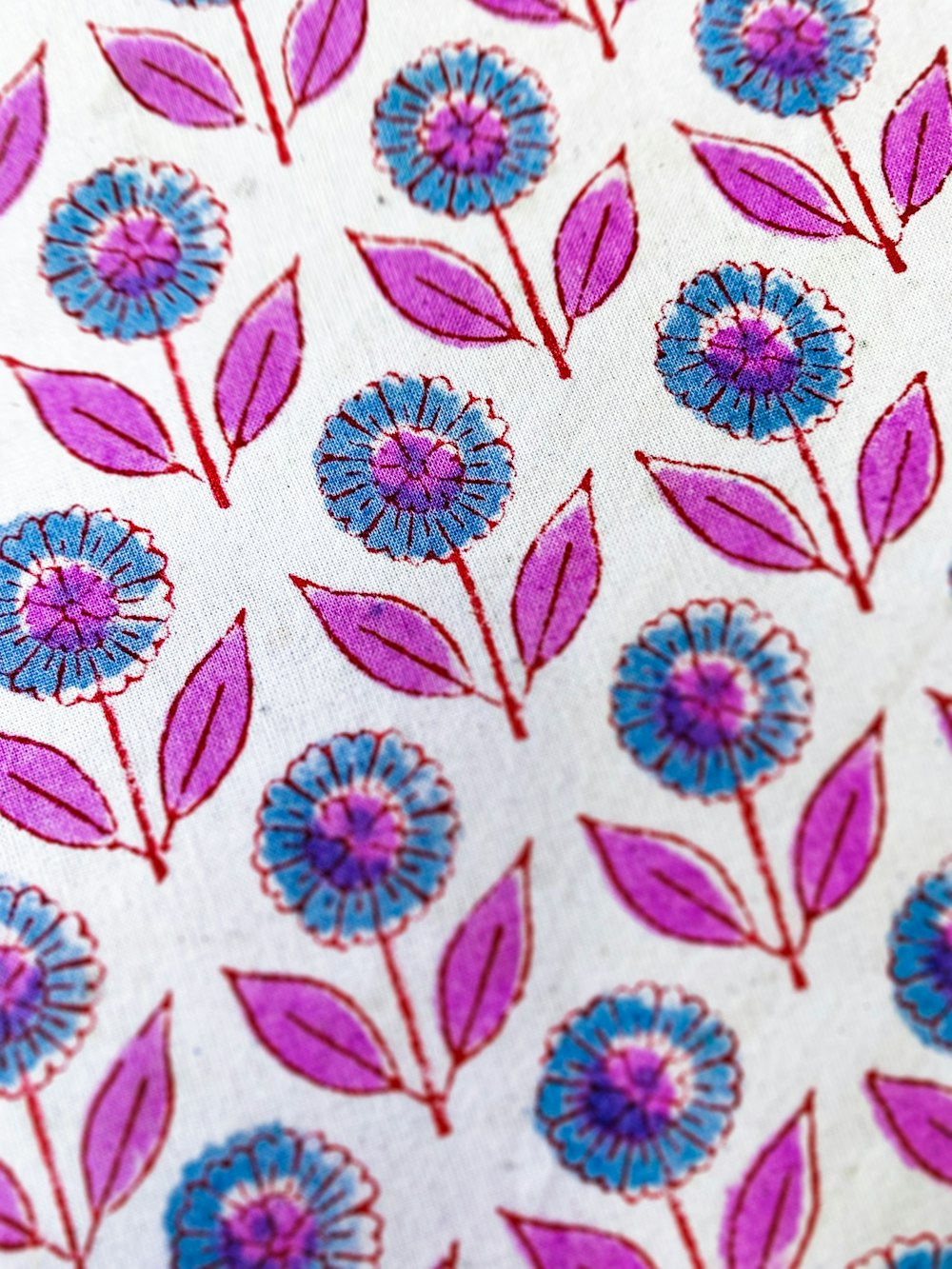 a close up of a pink and blue flower pattern on a white background