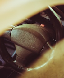 Close-up of a shiny Suzuki car interior highlighting the dashboard and steering wheel