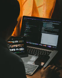 a man sitting in front of a laptop computer