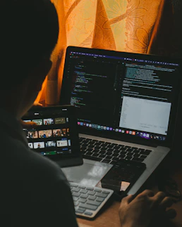 a man sitting in front of a laptop computer