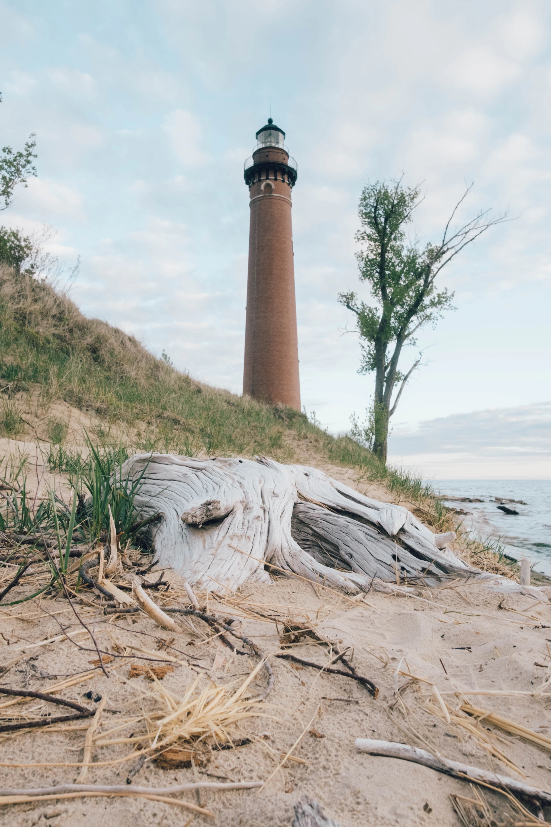 a light house sitting on top of a sandy beach